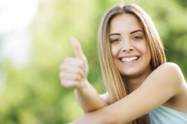 Young woman giving thumbs up